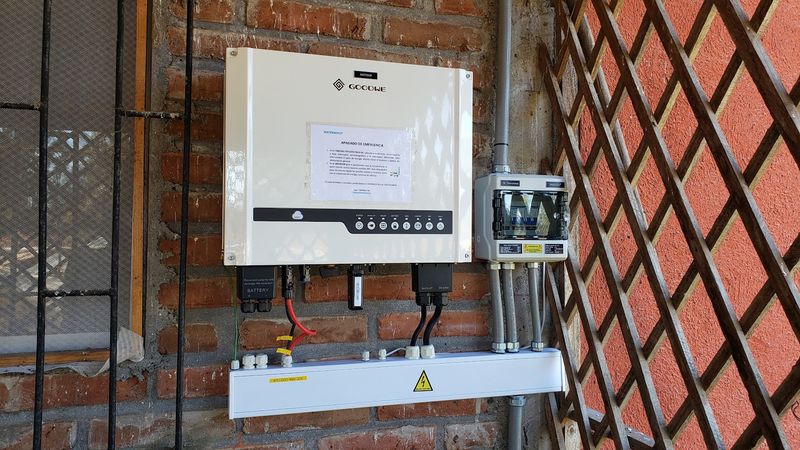 Inversor fotovoltaico y protecciones montados en muro de ladrillo